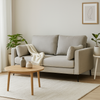 Modern living room with a gray sofa, wooden coffee table, and decorative plants.