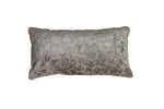 The Florian Cushion in Sand 60x30cm placed on a bed, creating a cozy and inviting atmosphere in the bedroom.