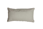 The Florian Cushion in Sand 60x30cm displayed on a sofa, adding a touch of luxury and comfort to the living room.