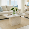 Living room with beige sofa, marble coffee table, and large windows.