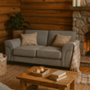 Cozy living room with a gray sofa, wooden coffee table, and stone fireplace.