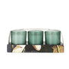 Decorative home accessories with scented candles in elegant green glass

