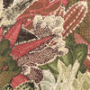 Decorative green cushion with textured jacquard fabric.