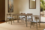 Oak dining chairs with modern walnut design.
