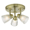 Antique brass bathroom lighting with ribbed glass shades

