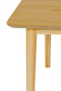 Sleek dining room table in natural oak for modern decor.
