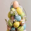 Festive centerpiece with bright ornaments for Easter decoration.