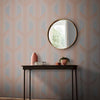 Stylish Graham & Brown wallpaper with a pink geometric pattern in rose gold.