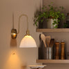 Hadano Wall Light Natural Brass and White Ceramic life style picture from the side