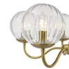 Jocelyn 5 Light Armed Pendant Natural Brass close view picture of the clear glass globe shade