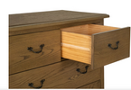 Tall chest of drawers with vintage metal handles.
