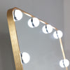 Long mirror with a sleek gold frame, ideal for bedrooms.

