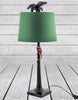 Decorative palm tree table lamp with monkey figurine and green lampshade.
