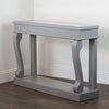"Narrow console table featuring intricate scroll design"
