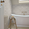 Contemporary triangle wallpaper in a neutral stone shade by Graham & Brown.
