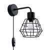 Black SUBA wall fixture creating ambiance in modern decor.
