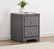 Gray nightstand with two drawers, a plant, and a book on a white wall background