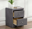 Gray nightstand with two drawers, a plant, and books on top in a room setting.