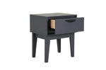 A lifestyle image featuring the Luna Bedside Table in Dark Grey in a stylish bedroom setup, demonstrating its ability to enhance the overall aesthetic of the space. The table's dark grey finish creates a sophisticated and cozy ambiance, perfect for a relaxing evening.