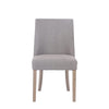 A frontal view of the Rosa Sand Linen Dining Chair, revealing its inviting seating and sophisticated aesthetic.